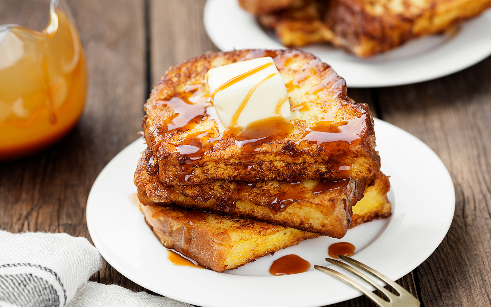 French toasts with butter and caramel sauce for breakfast.