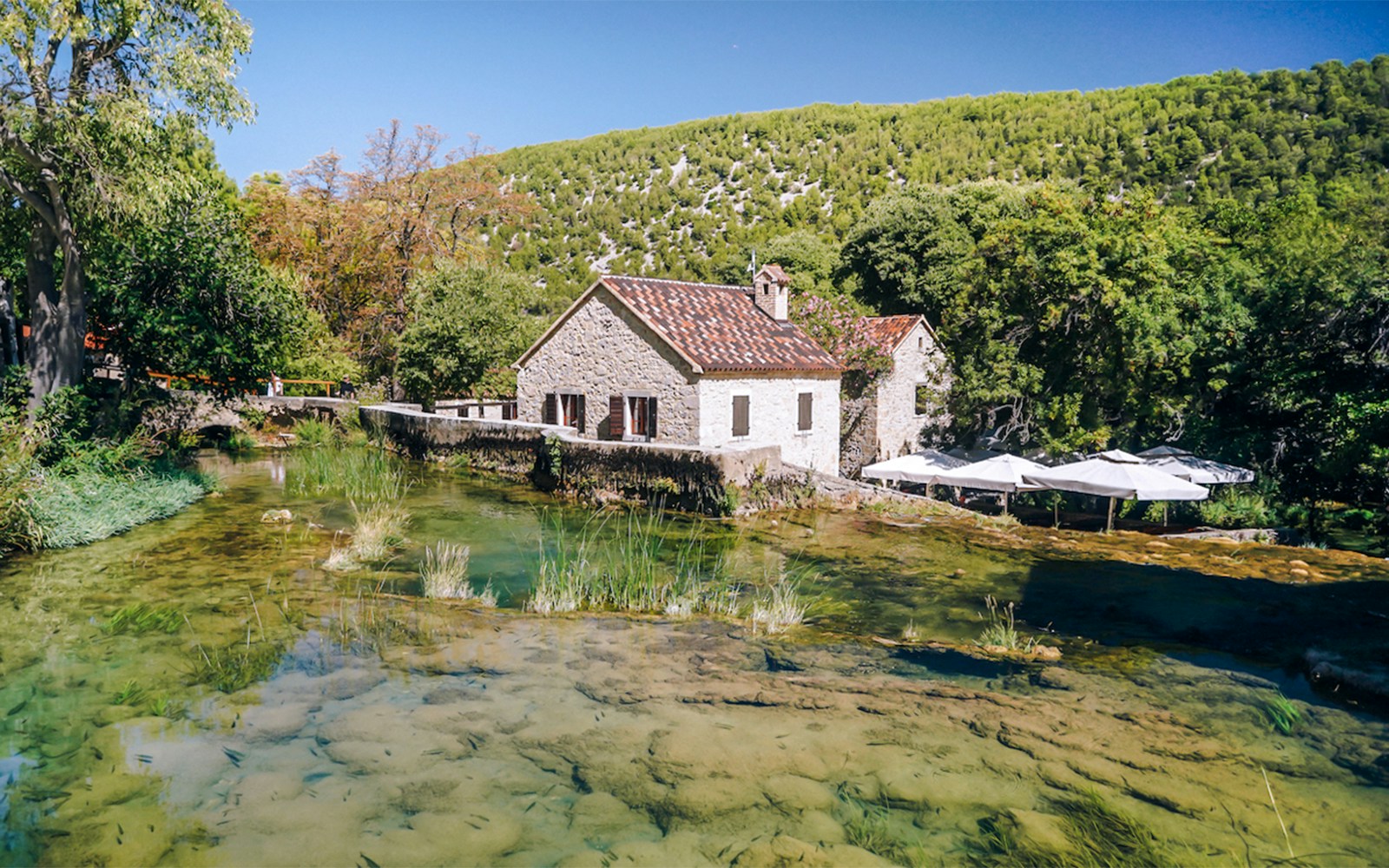 Stone house by a clear stream in Ethno village, Krka National Park.