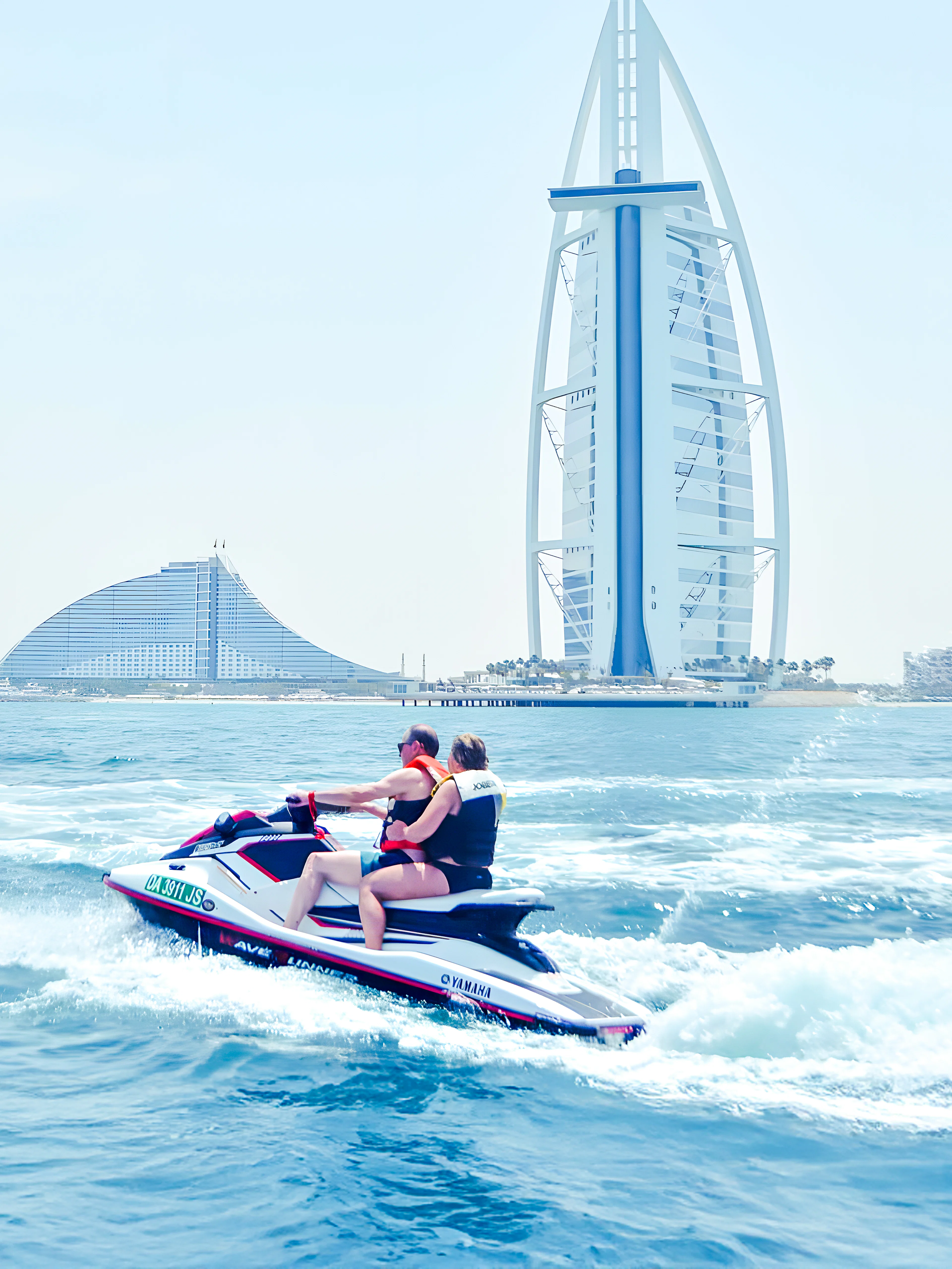 Jet ski riders in Dubai with Burj Al Arab in the background.