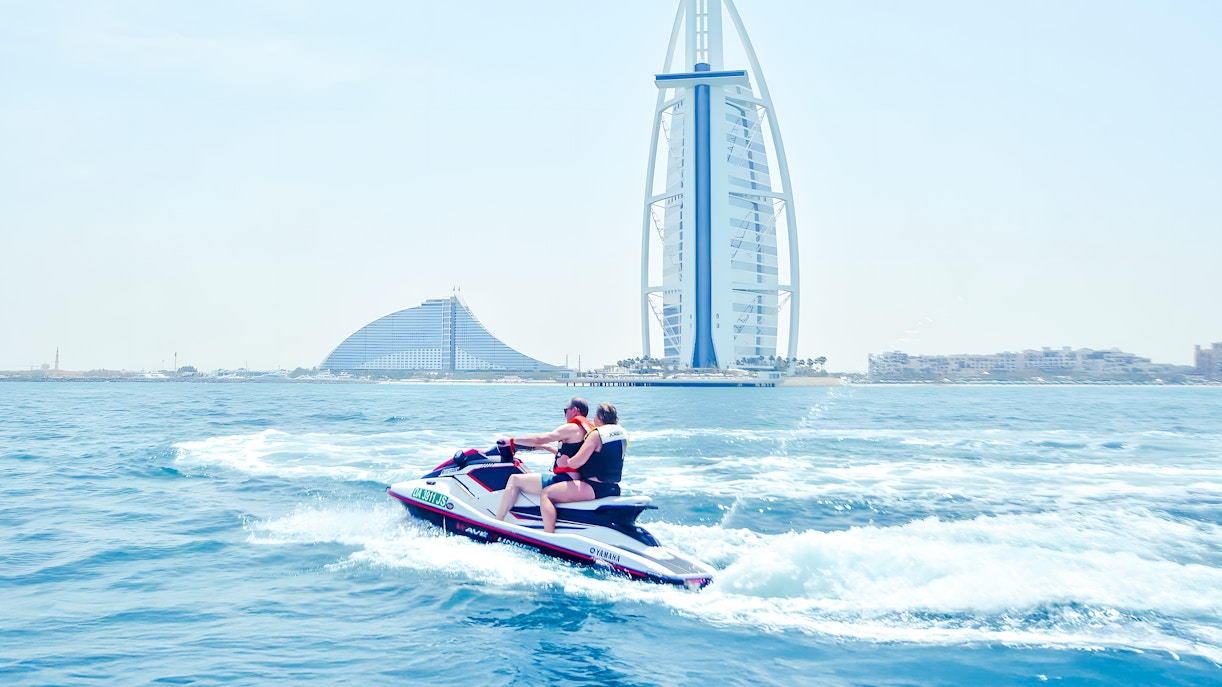 Jet ski riders in Dubai with Burj Al Arab in the background.