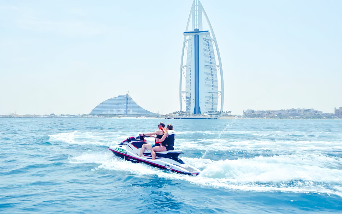 Jet ski riders in Dubai with Burj Al Arab in the background.