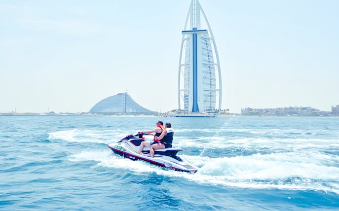 Jet ski riders in Dubai with Burj Al Arab in the background.