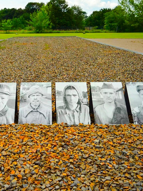 Portraits of prisoners displayed on gravel at Sachsenhausen Concentration Camp Memorial.
