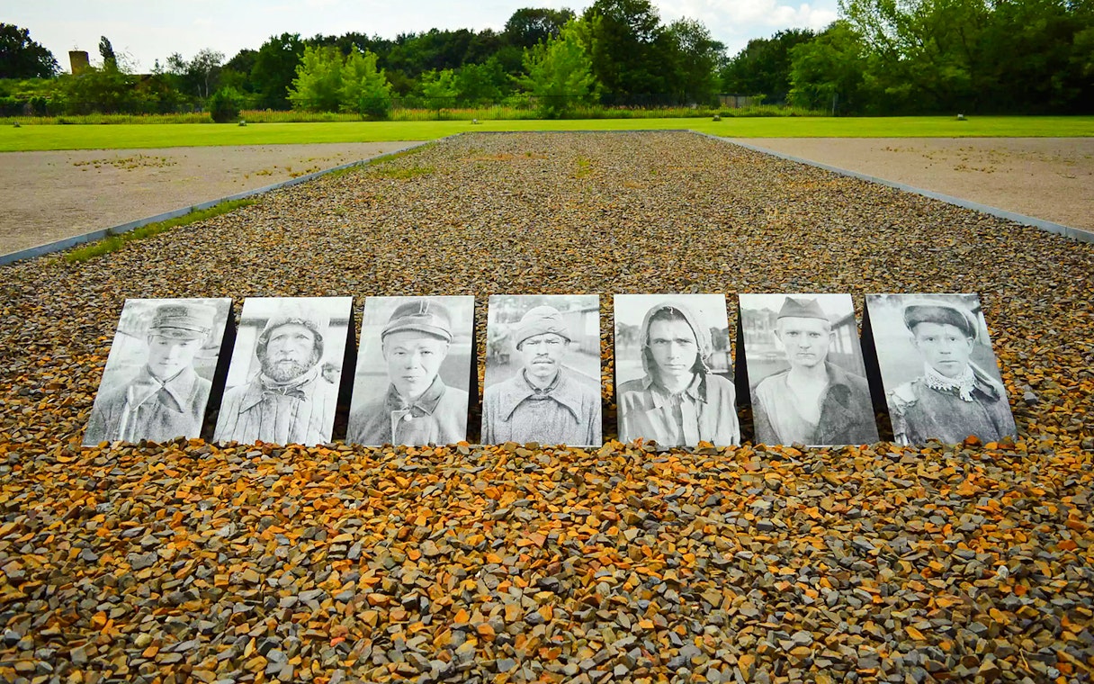 Portraits of prisoners displayed on gravel at Sachsenhausen Concentration Camp Memorial.