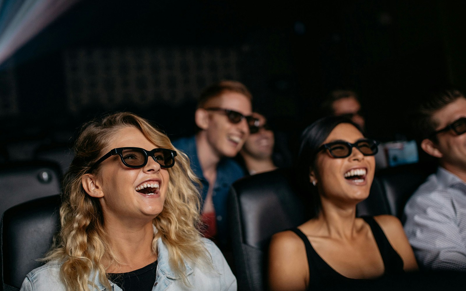 Visitors enjoying a 3D movie experience at the Intrepid Museum.