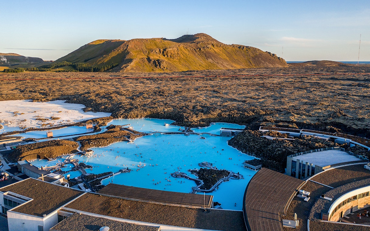 Blue Lagoon geothermal pool with surrounding lava fields in Iceland.