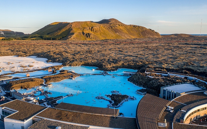 Blue Lagoon geothermal pool with surrounding lava fields in Iceland.