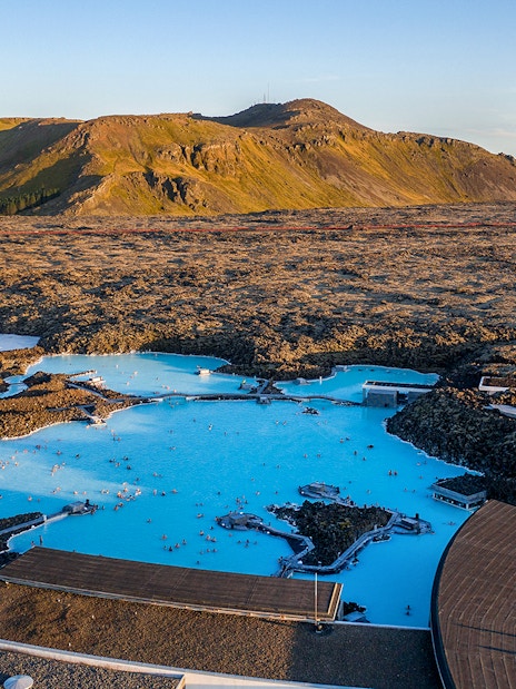 Blue Lagoon geothermal pool with surrounding lava fields in Iceland.