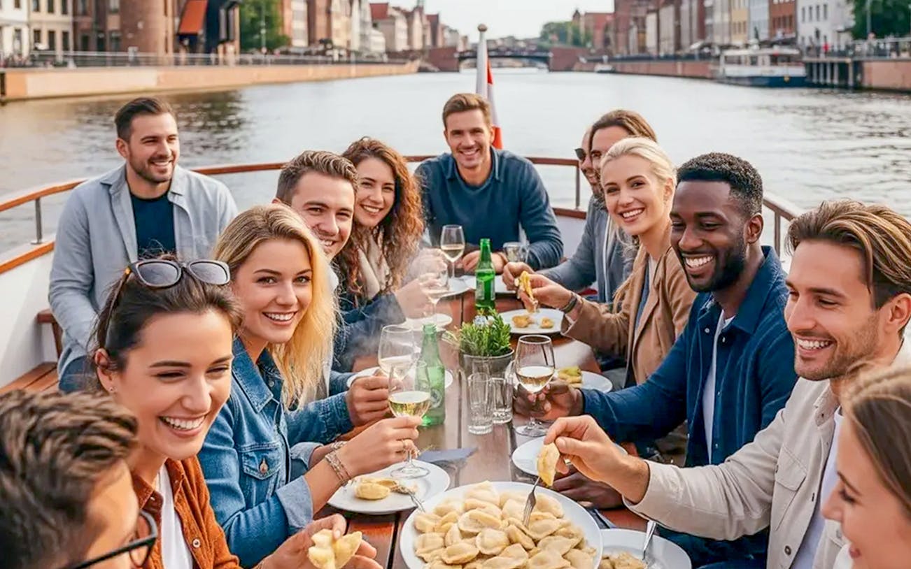 Guests enjoying pierogi tasting on a Motława River cruise in Gdansk.