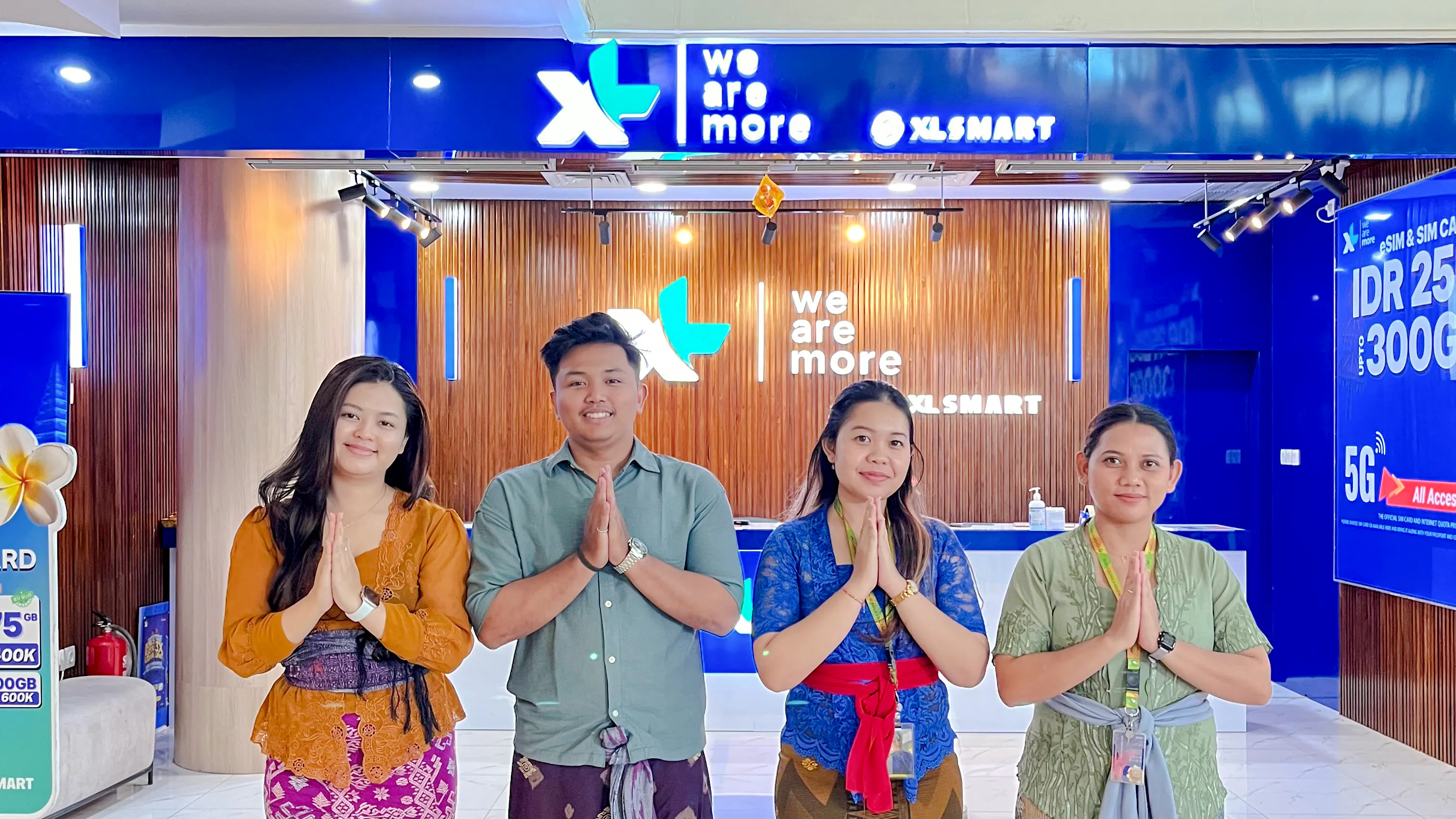 Staff at Bali airport SIM card collection point, welcoming visitors.