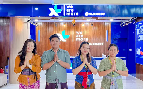Staff at Bali airport SIM card collection point, welcoming visitors.