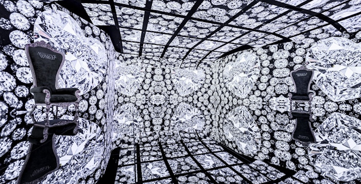 MIRACLEWORLD Osaka room with diamond-patterned walls and ornate chairs.
