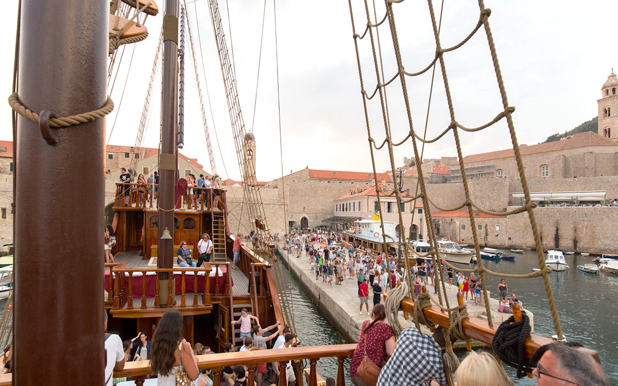 Tourists on a Game of Thrones-themed ship in Dubrovnik harbor, Croatia.