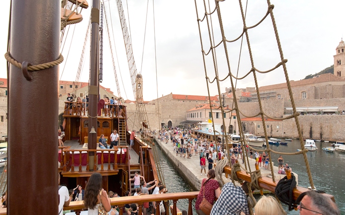 Tourists on a Game of Thrones-themed ship in Dubrovnik harbor, Croatia.