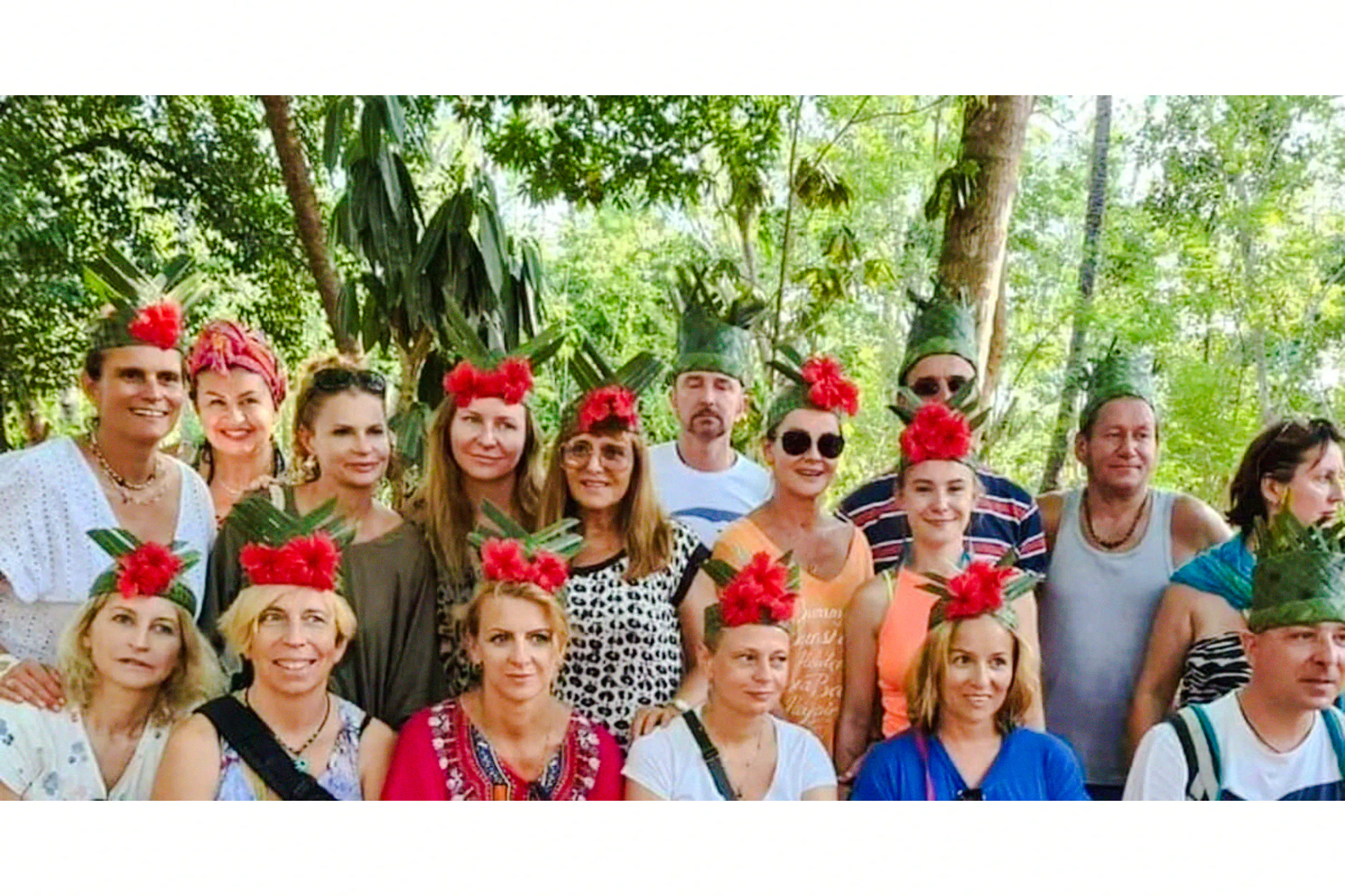 Tour group at Zanzibar spice farm wearing leaf and flower crowns.