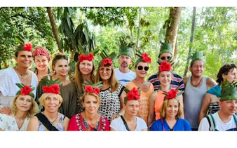 Tour group at Zanzibar spice farm wearing leaf and flower crowns.