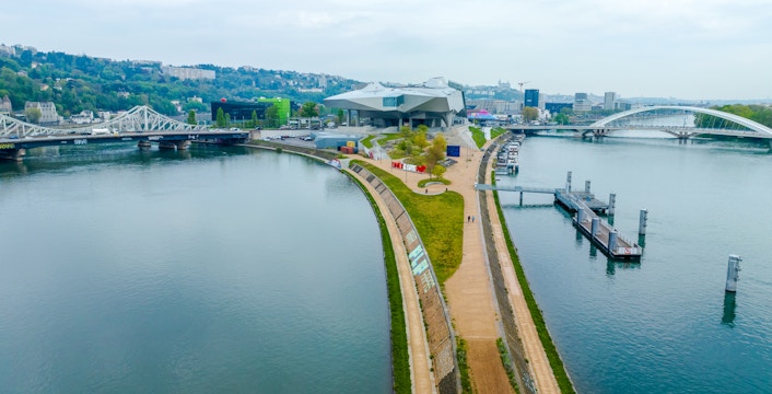 Musee des Confluences in Lyon, France, with surrounding river and bridges.