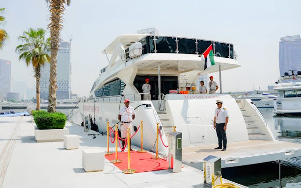 Yacht docked at Marasi Marina, Dubai, with crew ready to welcome guests.