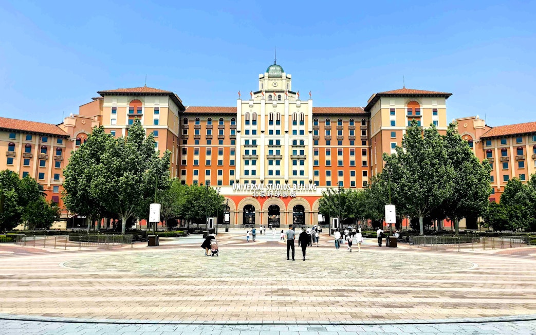 Entrance to Universal Studios Beijing with people walking in the plaza, China.