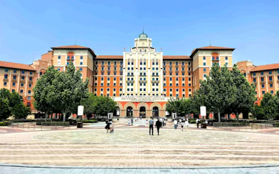 Entrance to Universal Studios Beijing with people walking in the plaza, China.