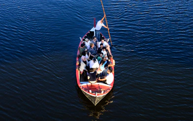 Group enjoying a guided boat tour on a Florentine gondola.