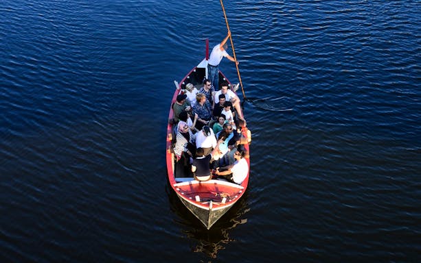 Group enjoying a guided boat tour on a Florentine gondola.