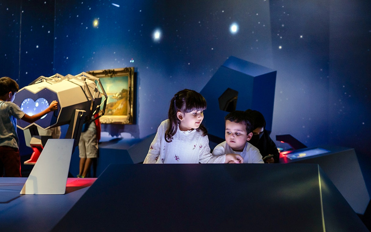 Children exploring interactive exhibits at Louvre Abu Dhabi.