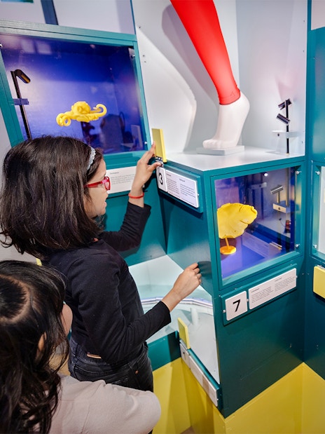 Children exploring interactive science exhibits with colorful displays.