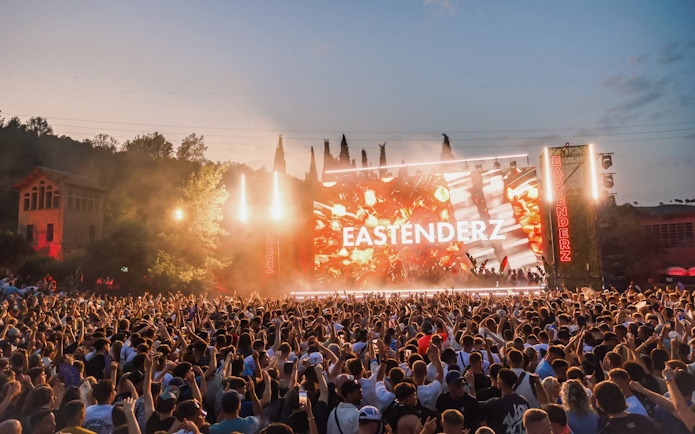 Crowd enjoying Eastenderz performance at outdoor venue in Ibiza.