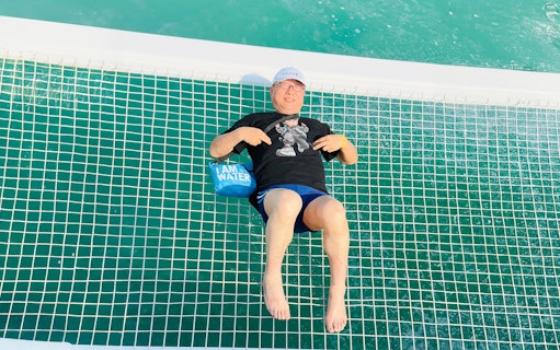 Man relaxing on a jacuzzi net during Langkawi Island hopping tour.