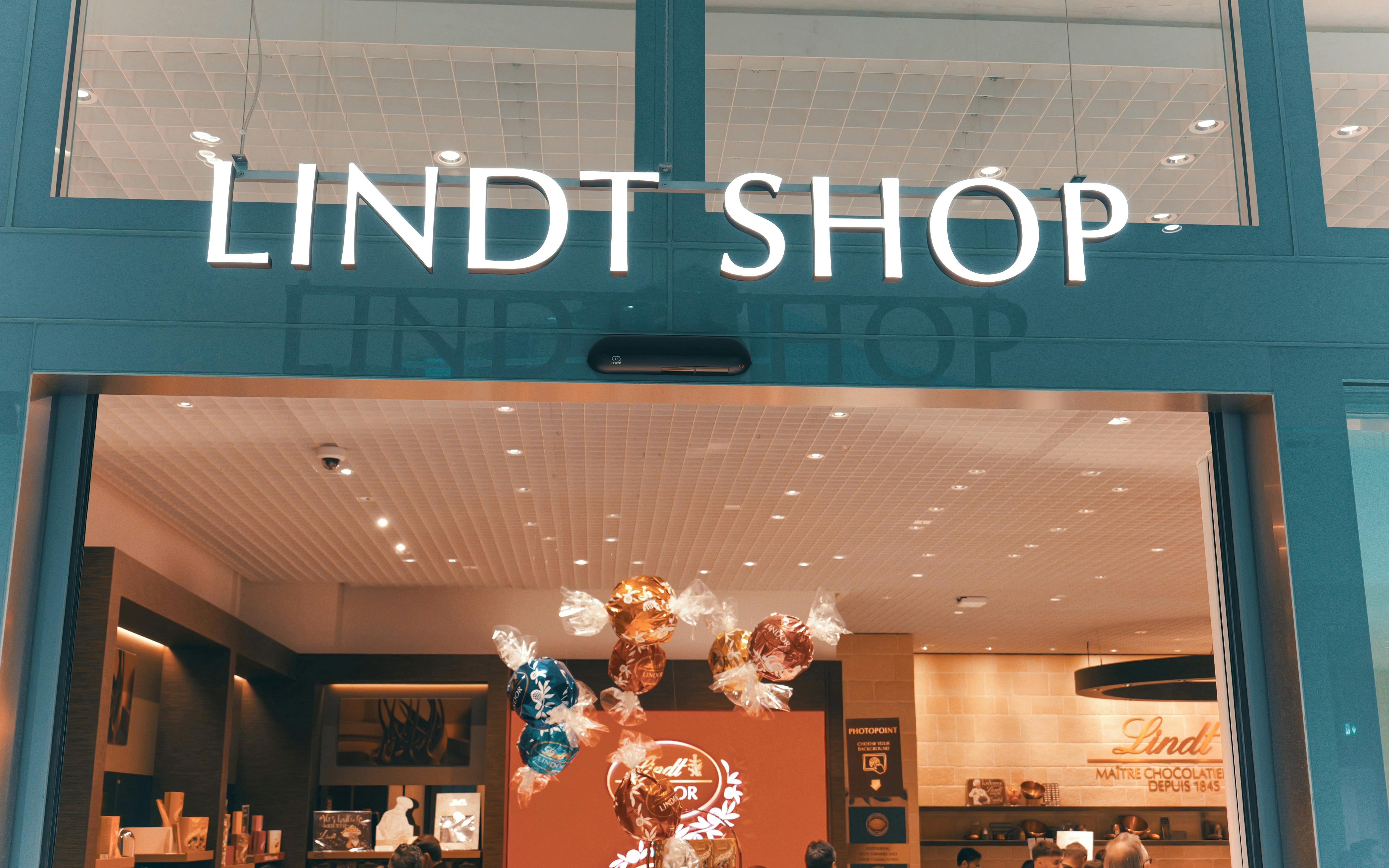 Lindt Chocolate Museum entrance with colorful chocolate displays inside.