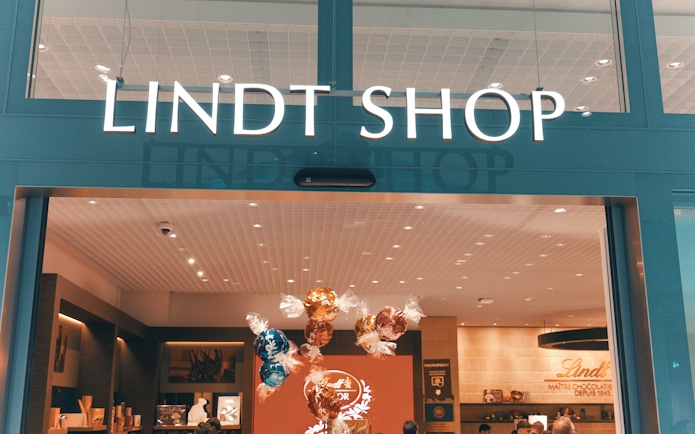 Lindt Chocolate Museum entrance with colorful chocolate displays inside.