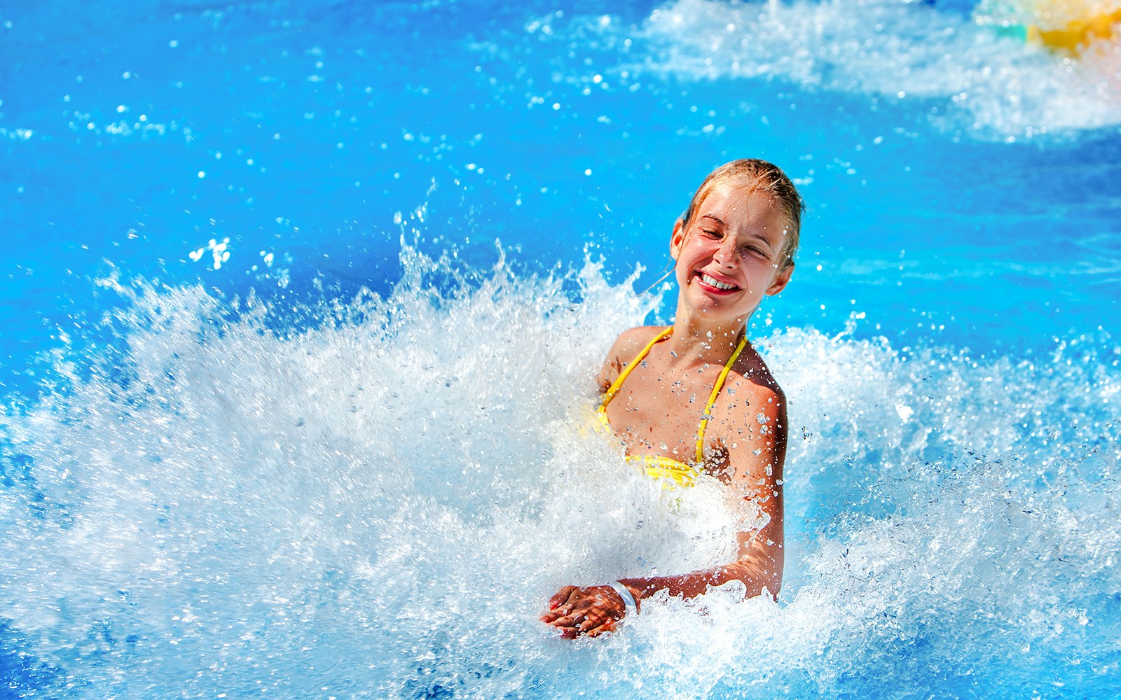 Woman enjoying waves at a water park.