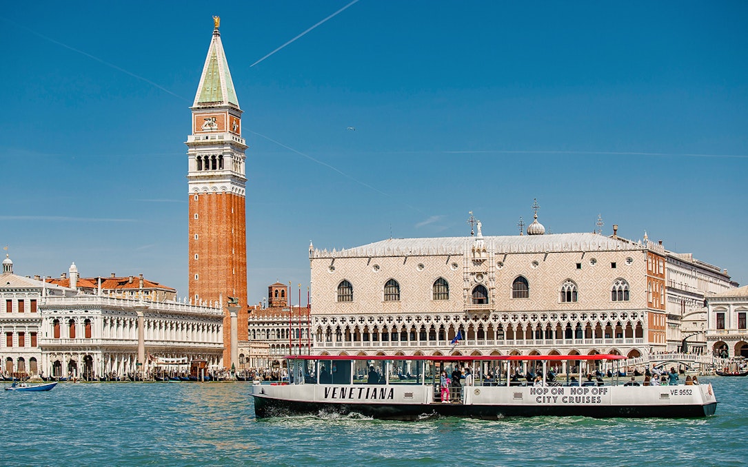 Venice boat tour passing St. Mark's Campanile and Doge's Palace.