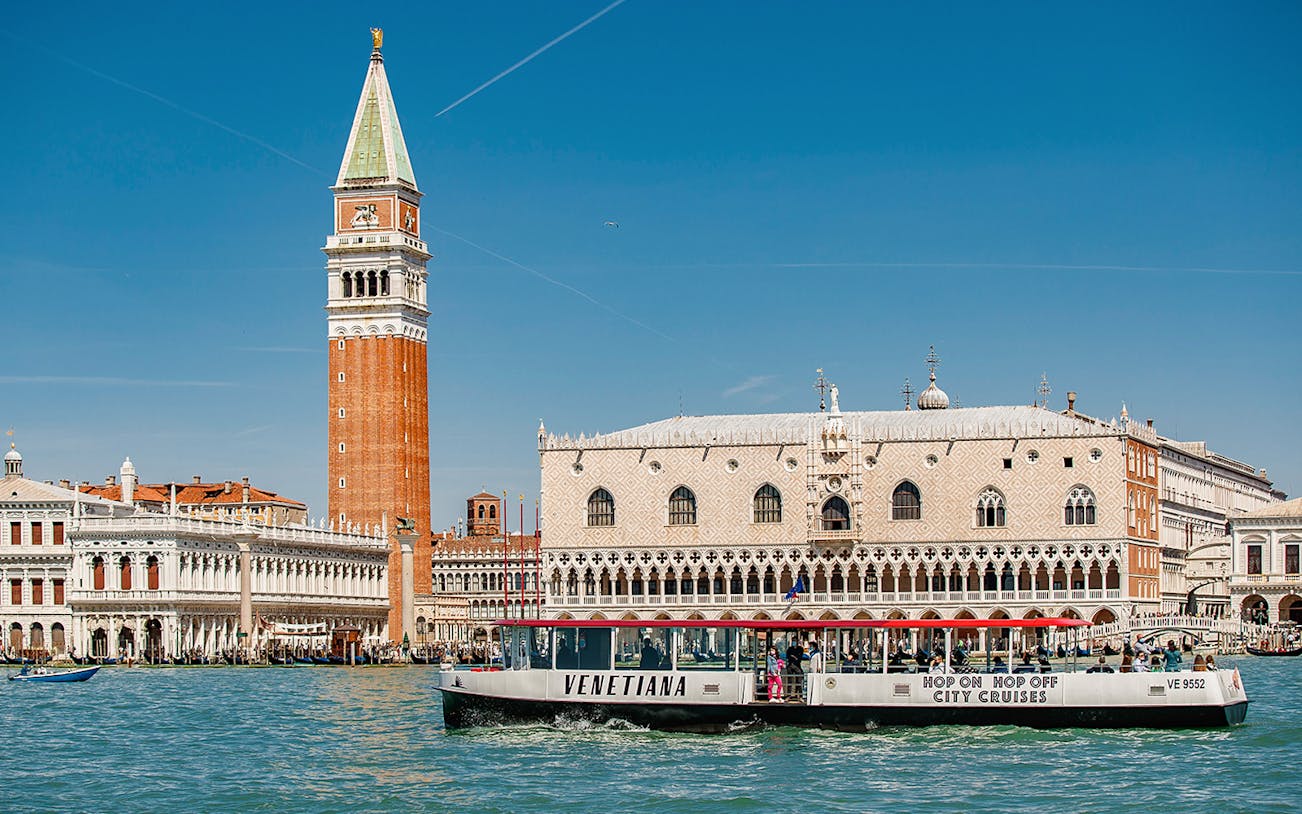 Venice boat tour passing St. Mark's Campanile and Doge's Palace.