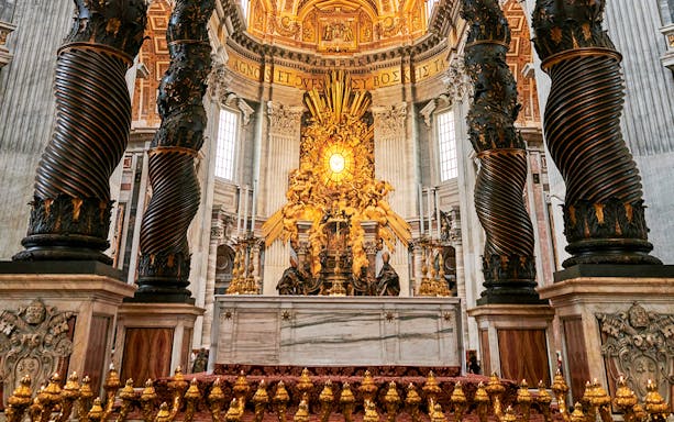 St. Peter's Basilica altar with ornate columns and golden artwork, Vatican City.