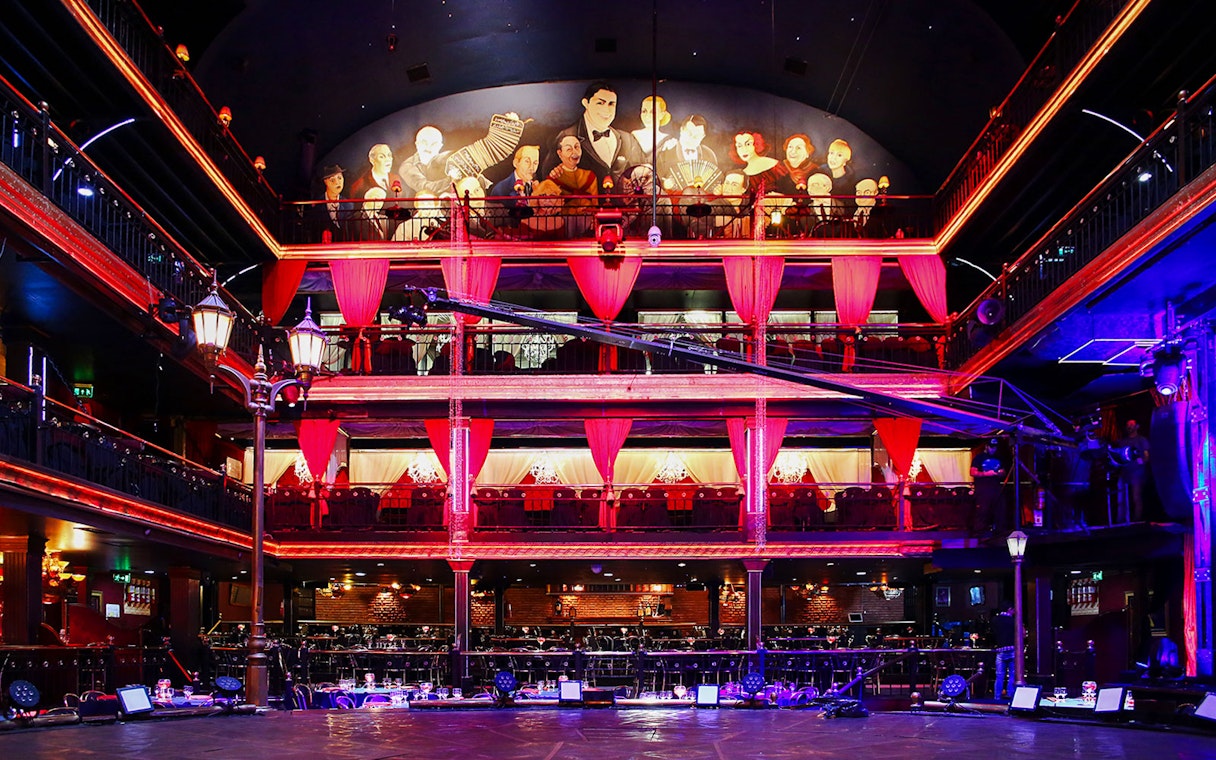 Señor Tango Show stage area with vibrant lighting and balcony seating.