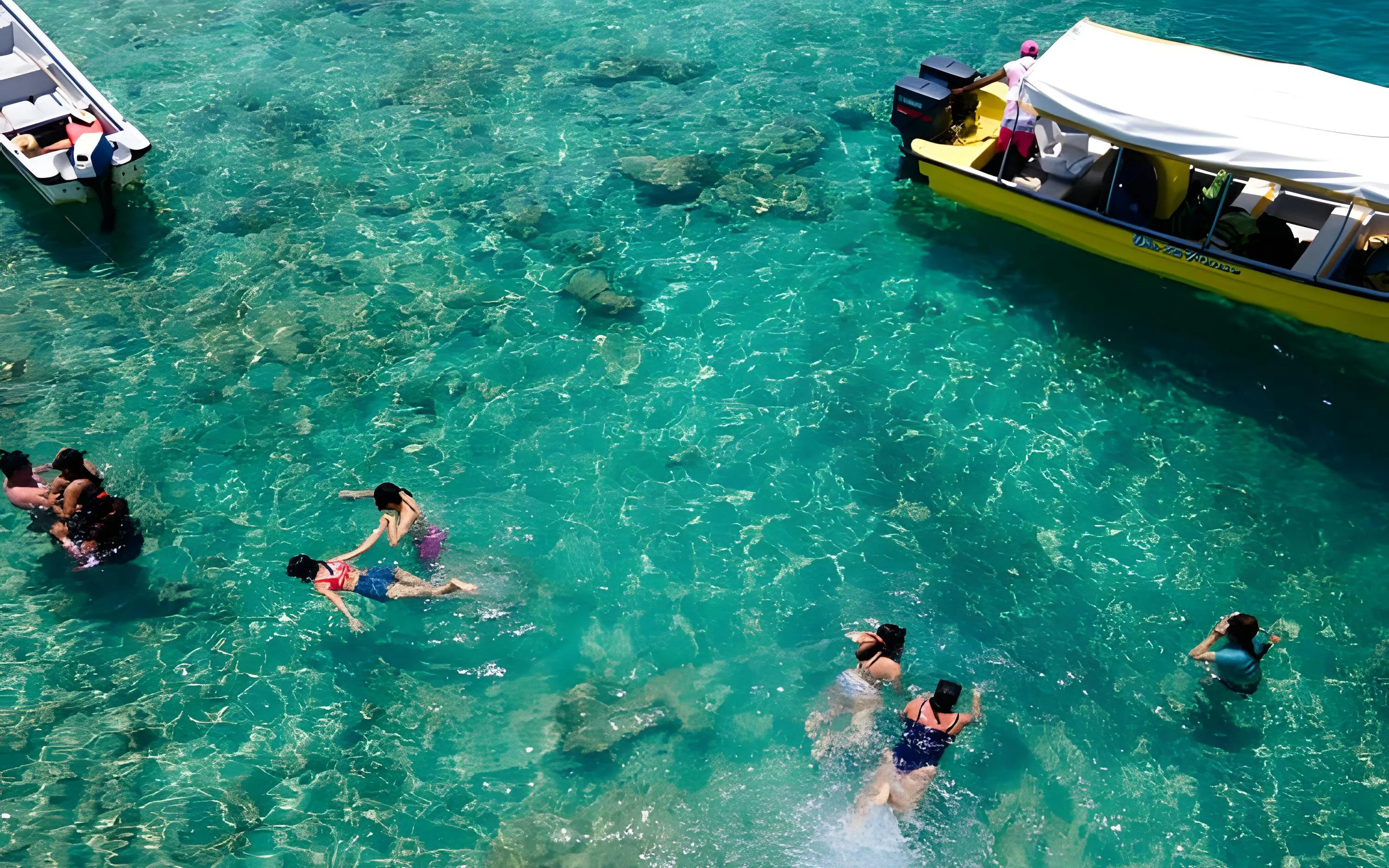 Swimming in clear blue water near a boat at Rosario Island, Cartagena, Colombia.