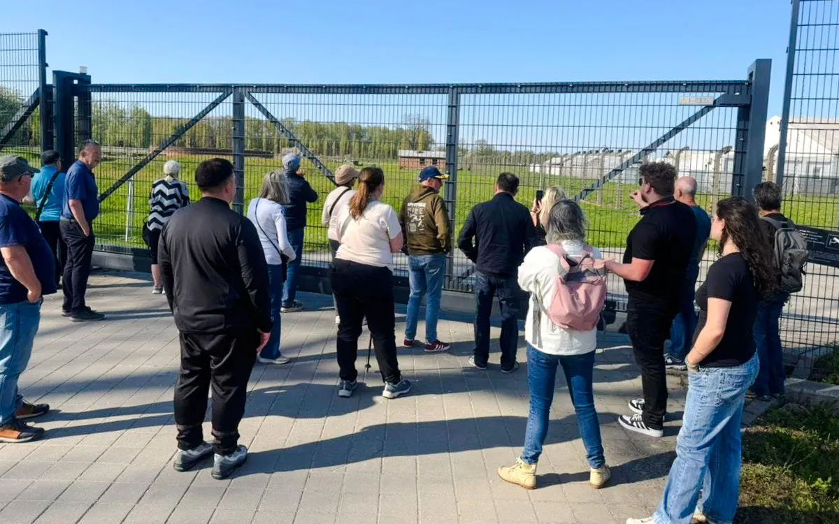 Visitors observing Auschwitz grounds during Outside the Walls Guided Tour.