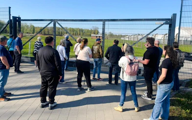 Visitors observing Auschwitz grounds during Outside the Walls Guided Tour.