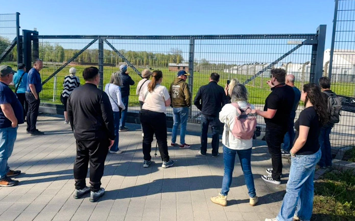 Visitors observing Auschwitz grounds during Outside the Walls Guided Tour.