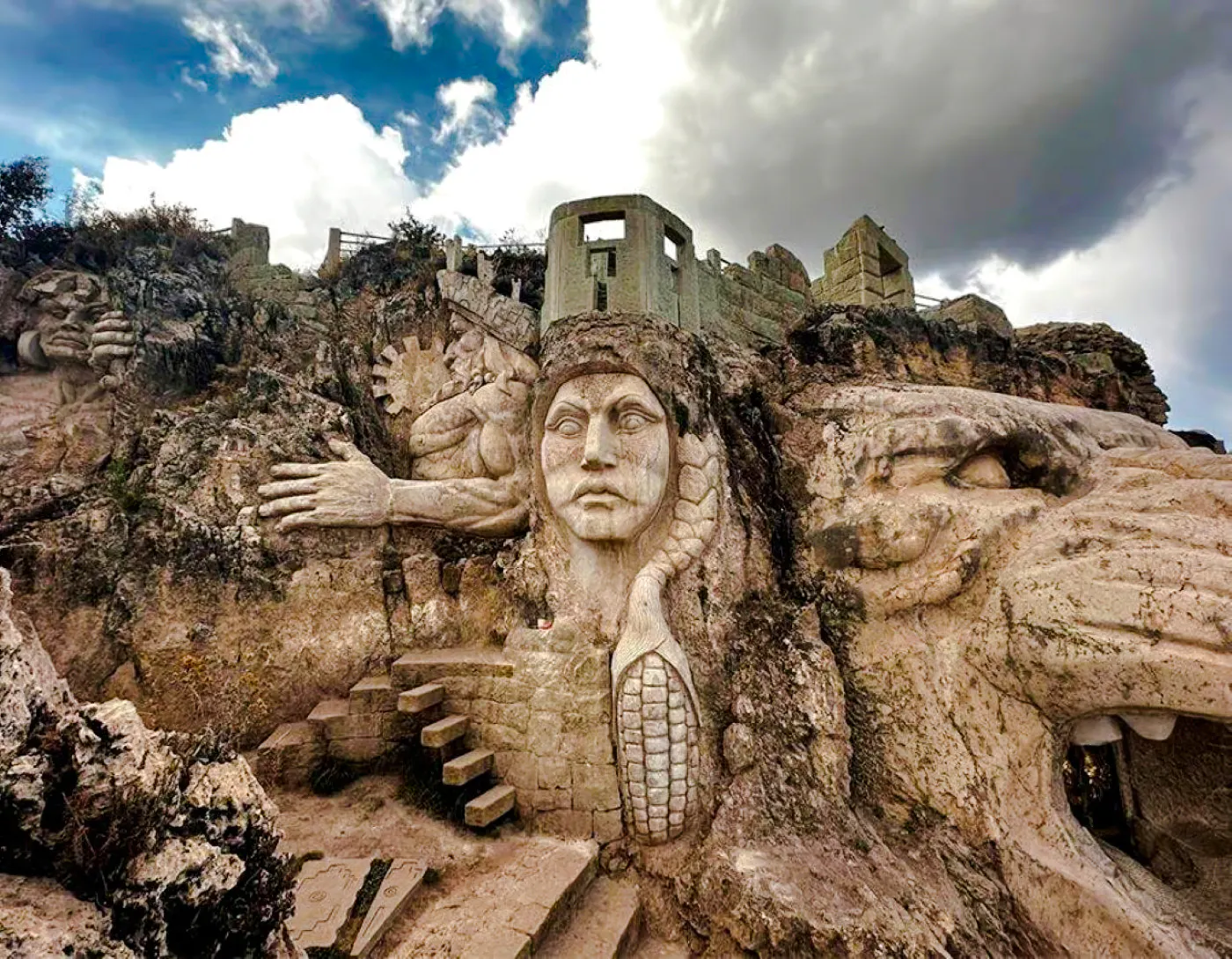 Ancient stone carvings at Abode of the Gods, Cusco, featuring mythical figures and intricate designs.