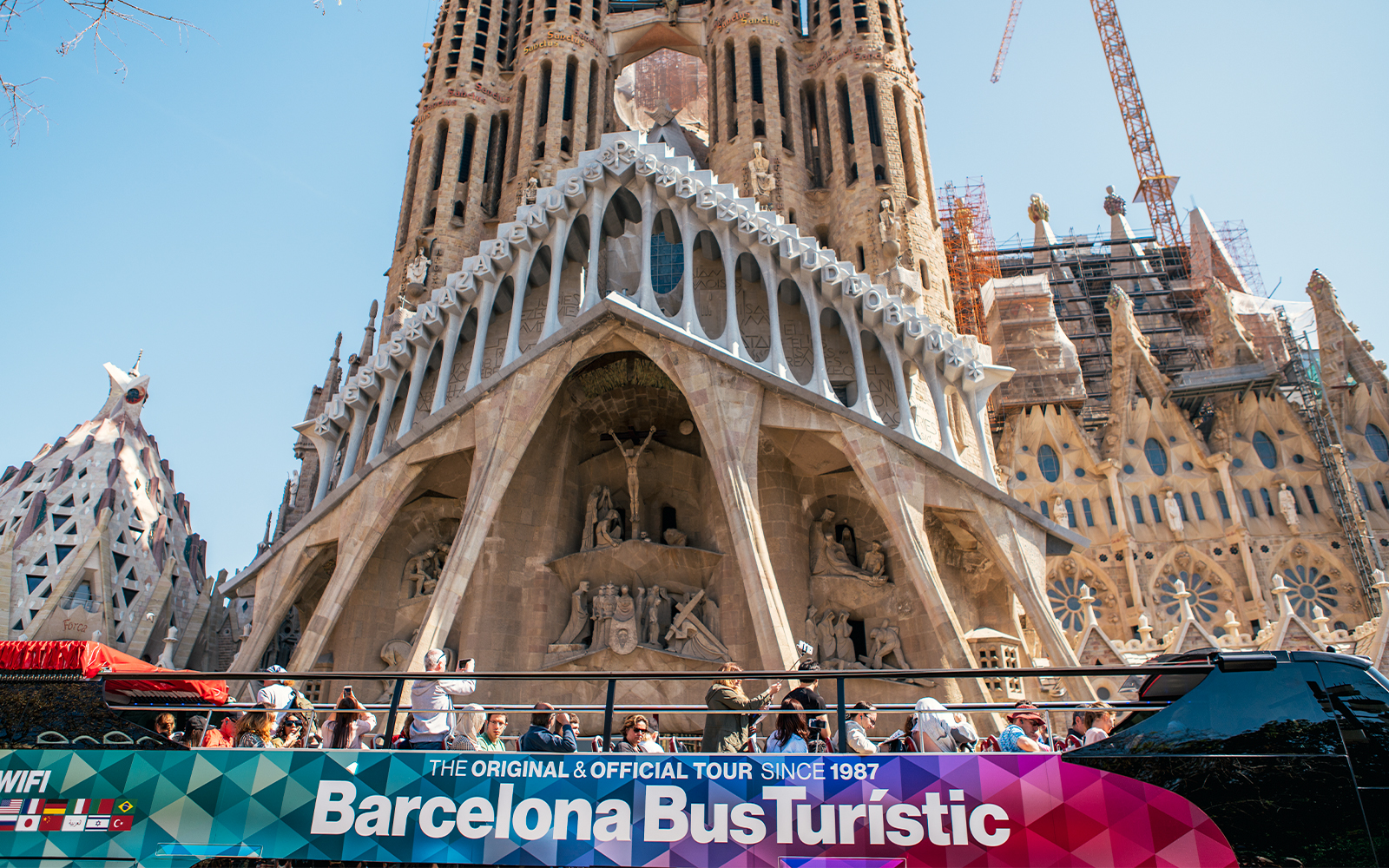 Barcelona hop-on hop-off bus in front of Sagrada Familia.