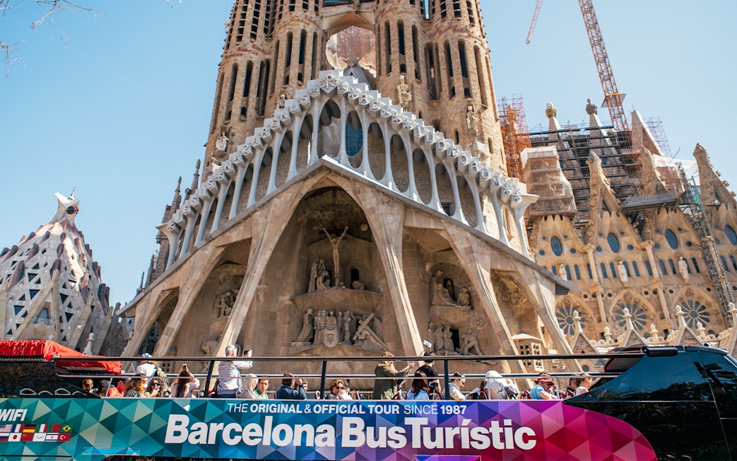 Barcelona hop-on hop-off bus in front of Sagrada Familia.