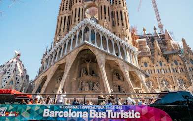 Barcelona hop-on hop-off bus in front of Sagrada Familia.