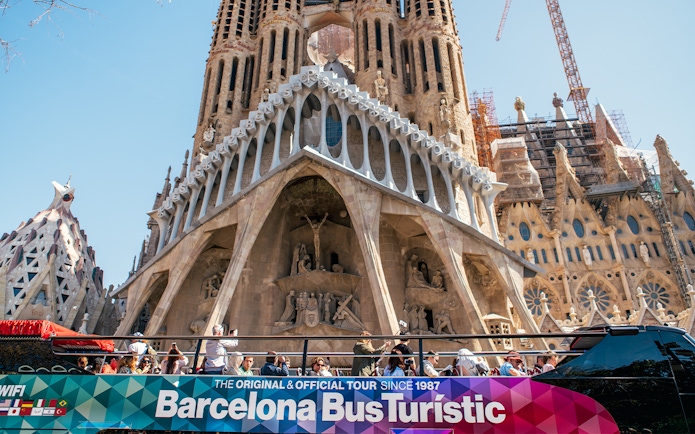 Barcelona hop-on hop-off bus in front of Sagrada Familia.