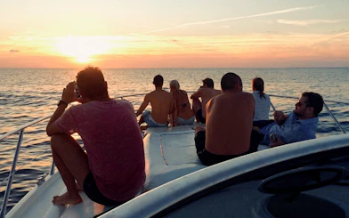 Tourists enjoying sunset on a boat in Cartagena's Bay.