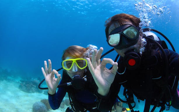 Scuba divers signaling OK underwater in the Mediterranean Sea.