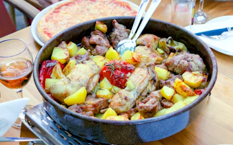 Traditional Croatian peka with mixed meat and vegetables in a baking dish.