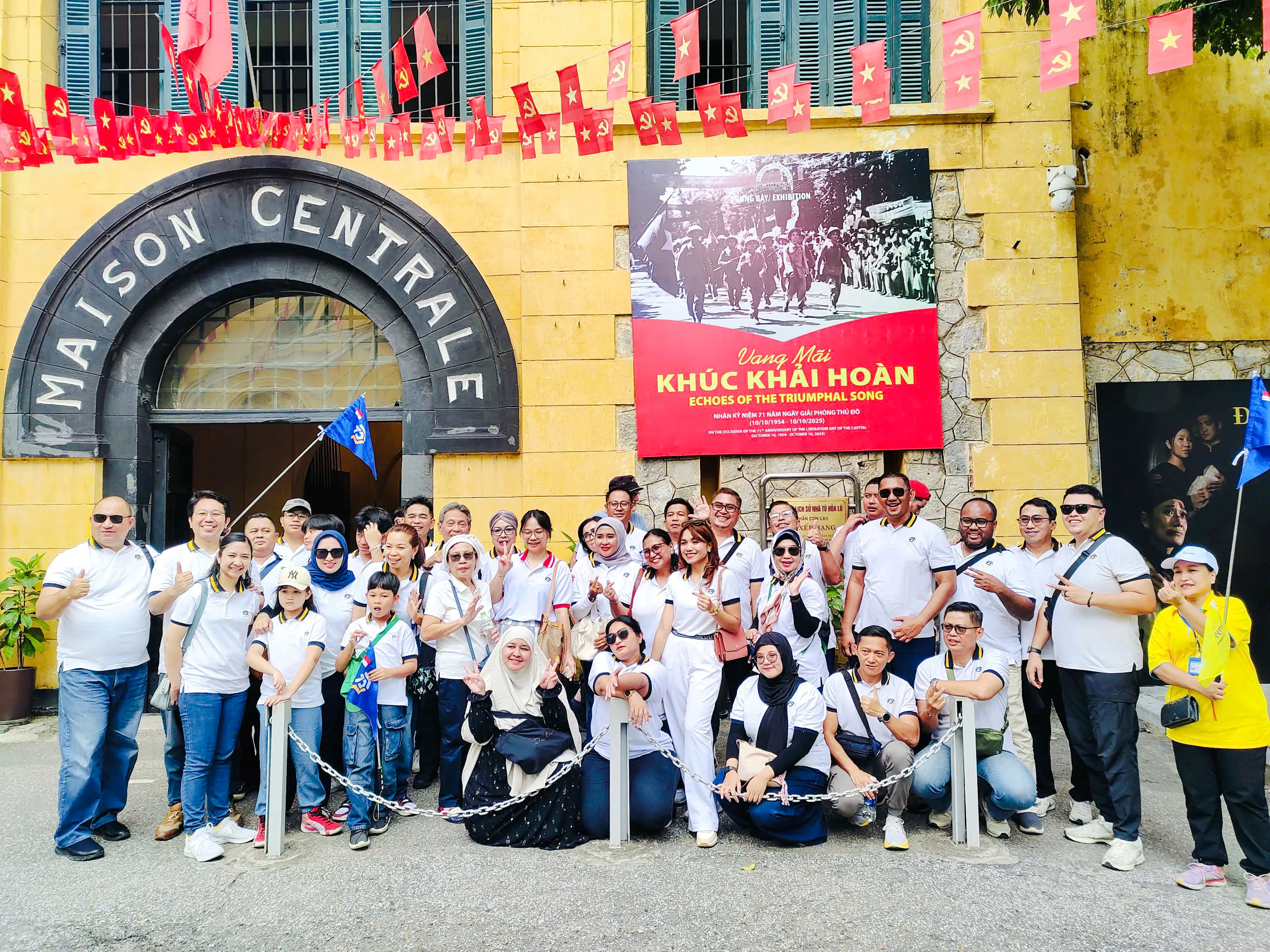 Group of tourists outside Hoa Lo Prison entrance during Hanoi walking tour.